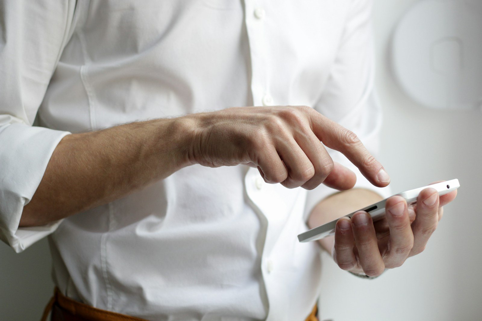 Hands dialling a number on a phone
