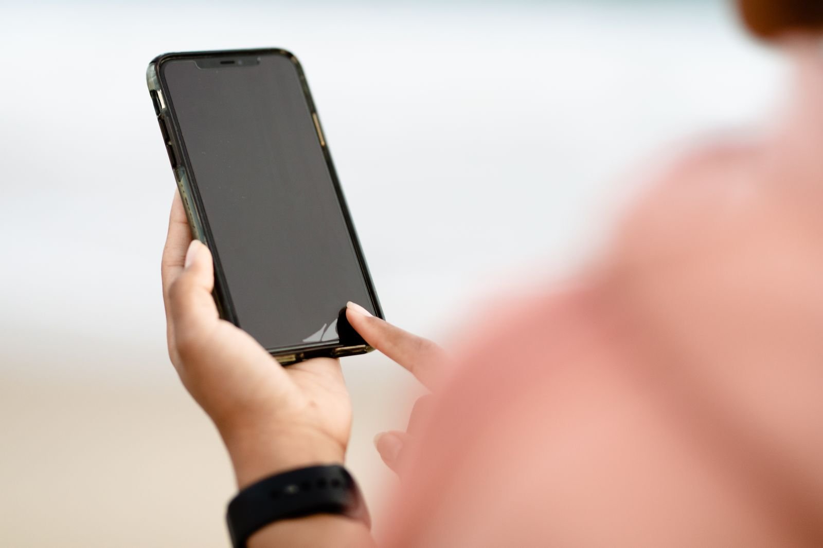 Hand resting on a phone touchscreen