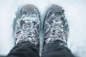 Lace-up winter boots standing in fresh snow